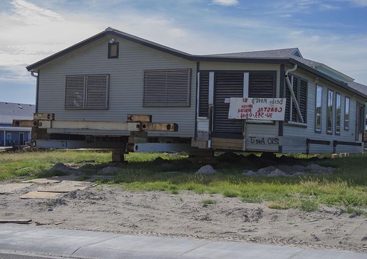 A Port Aransas home sits on beams waiting to be moved