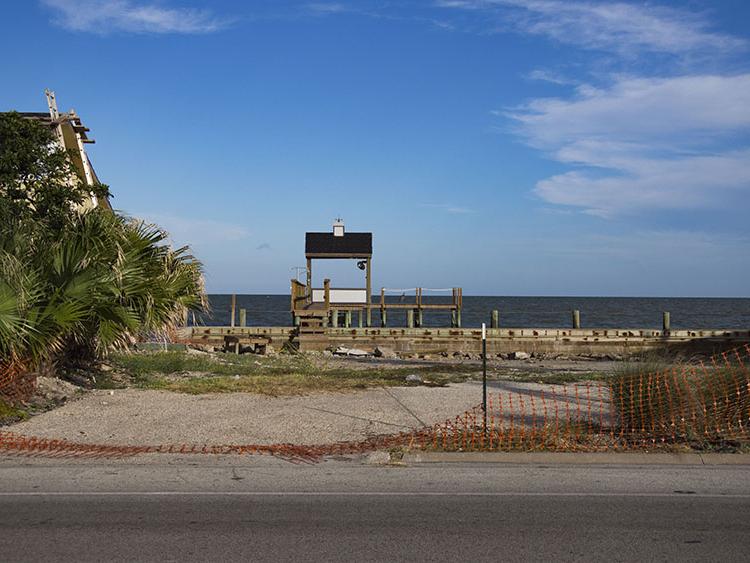 A pier sits behind an empty lot in the Key Allegro neighborhood in Rockport